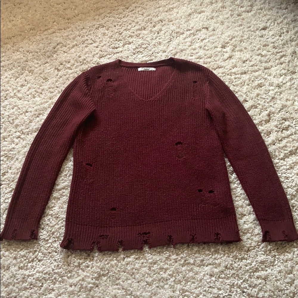 Maroon distressed sweater.